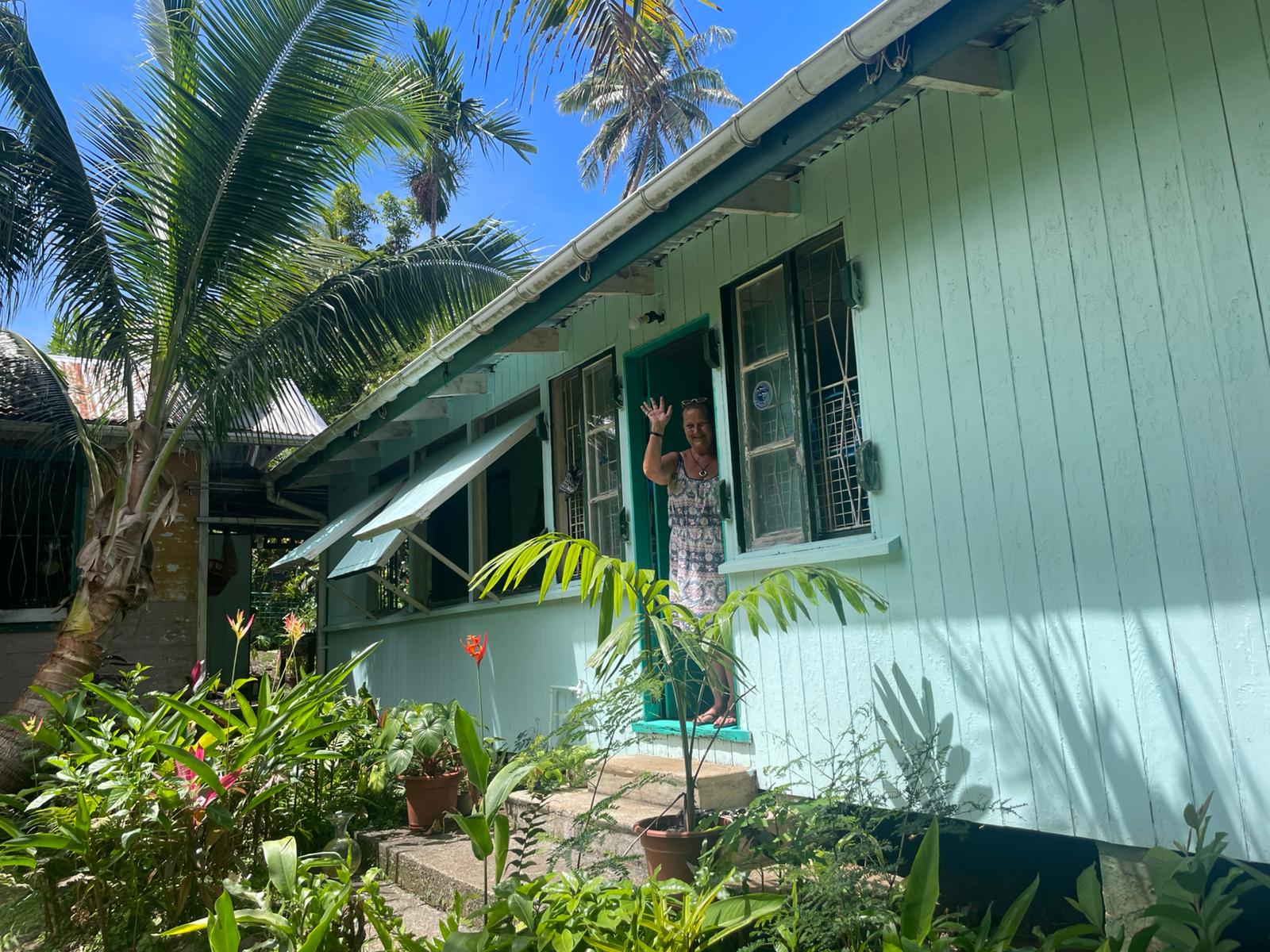 Alice welcoming guests from the veranda