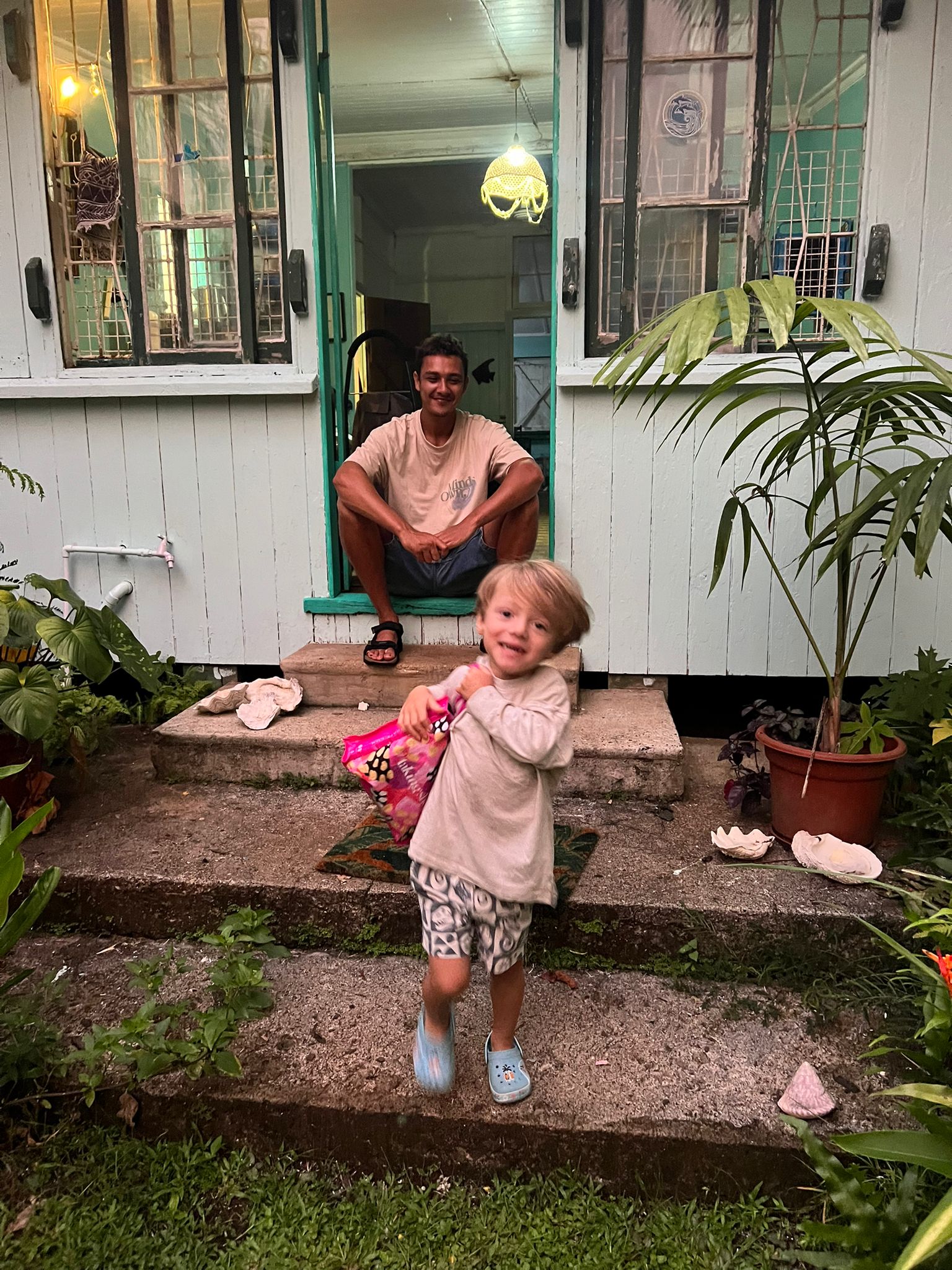 Dom on the front porch with a young guest